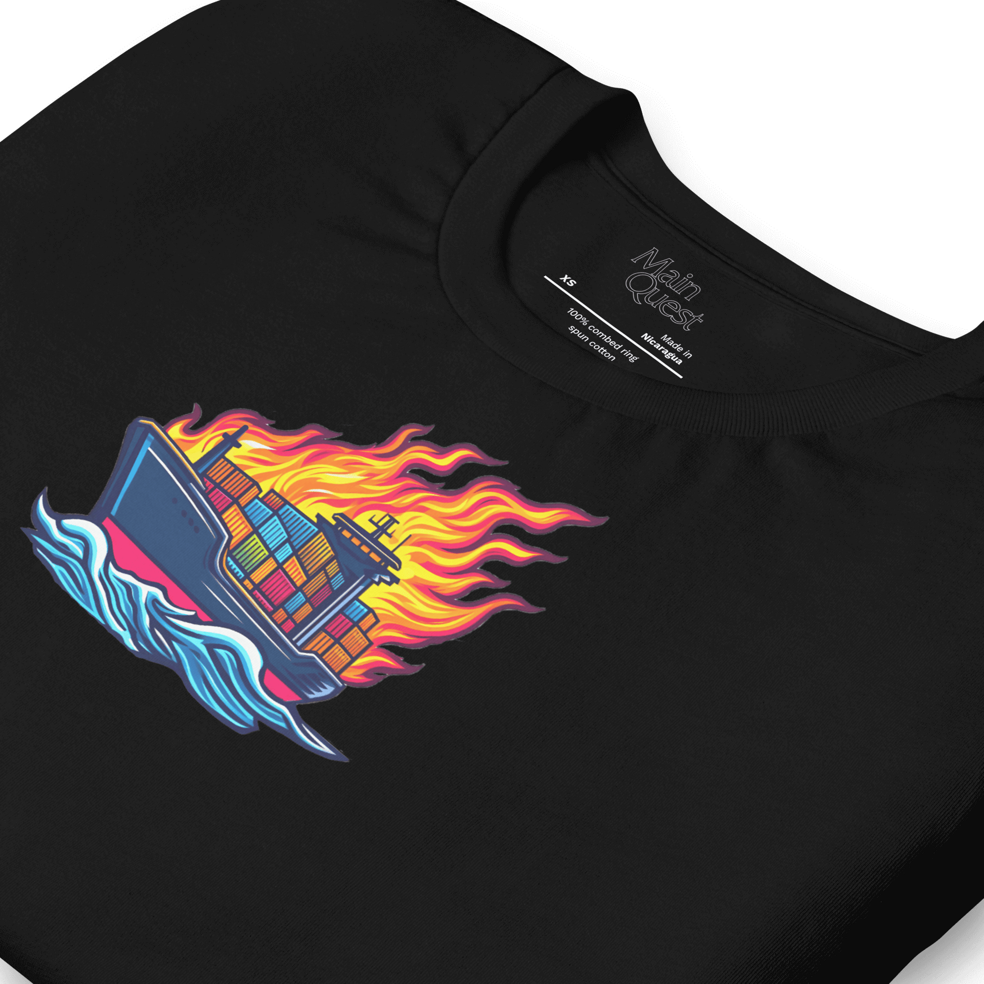 Close-up of a black t-shirt with a large graphic printed on the chest depicting a cargo boat full of shipping containers sailing while a massive flame engulfs the ship above deck
