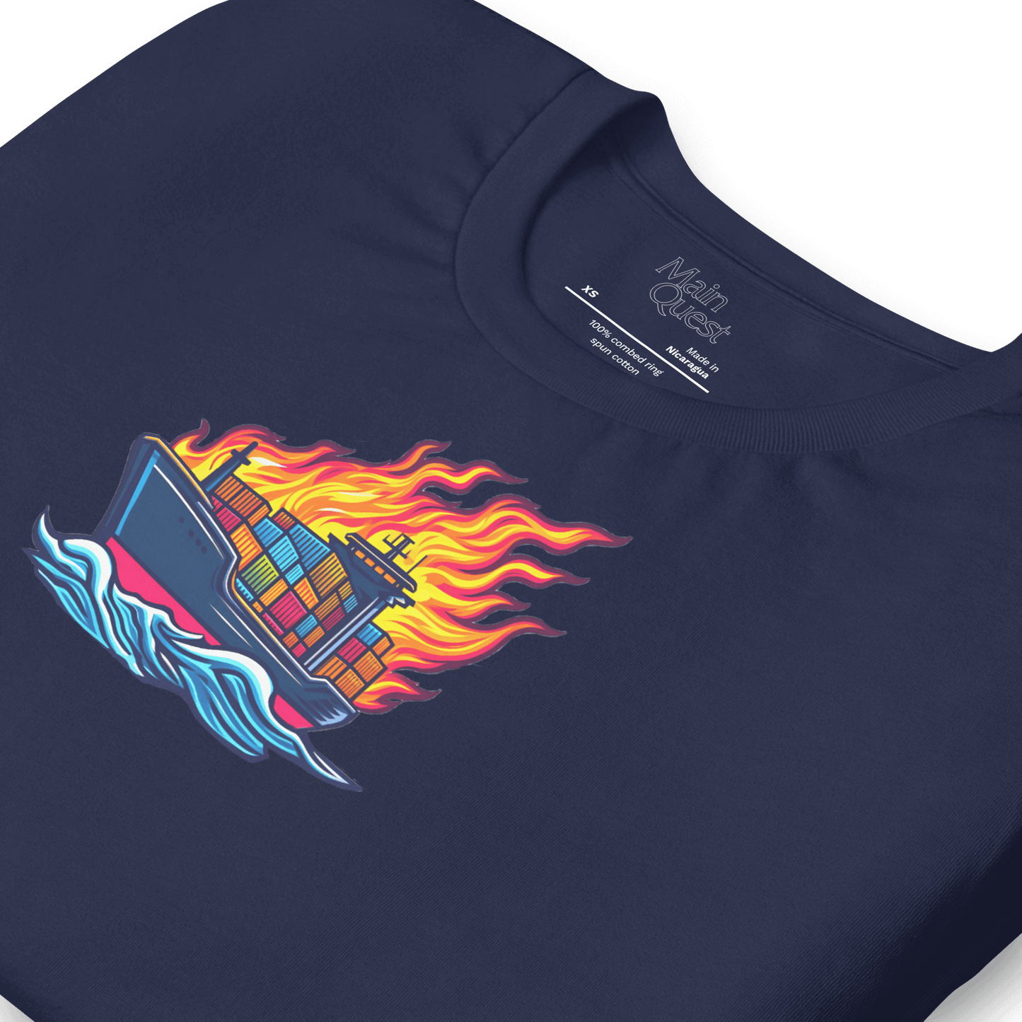 Close-up of a navy blue t-shirt with a large graphic printed on the chest depicting a cargo boat full of shipping containers sailing while a massive flame engulfs the ship above deck