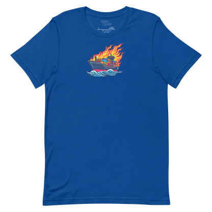 A royal blue t-shirt with a large graphic printed on the chest depicting a cargo boat full of shipping containers sailing while a massive flame engulfs the ship above deck