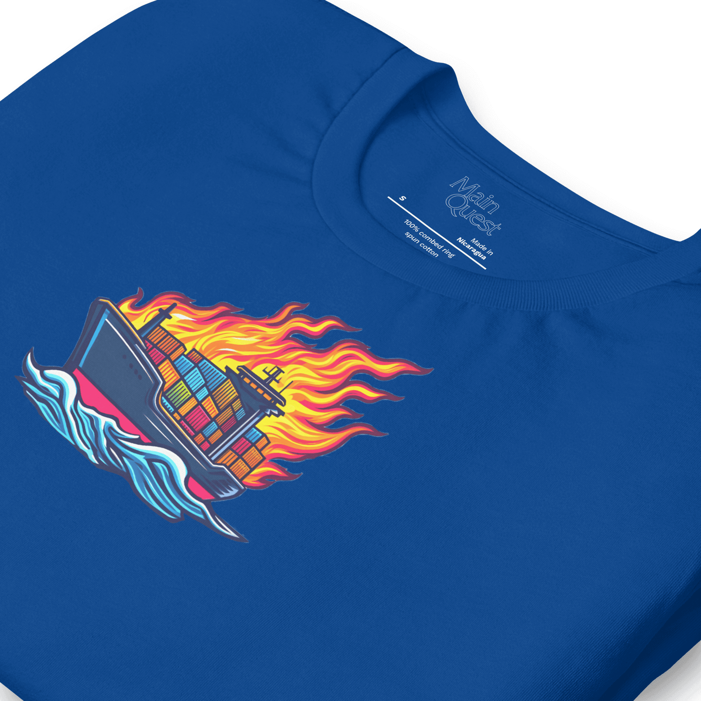 Close-up of a royal blue t-shirt with a large graphic printed on the chest depicting a cargo boat full of shipping containers sailing while a massive flame engulfs the ship above deck